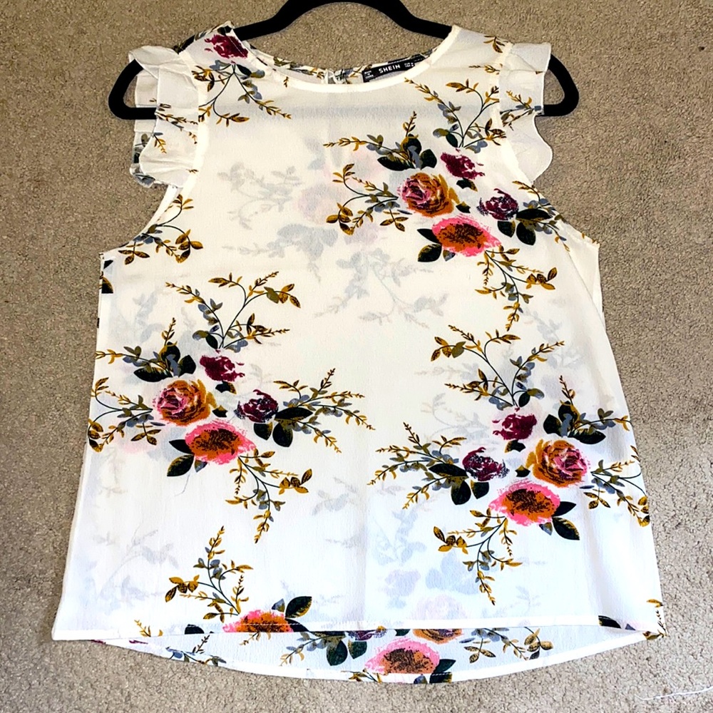 Sleeveless Blouse with ruffled shoulders and a beautiful floral print.